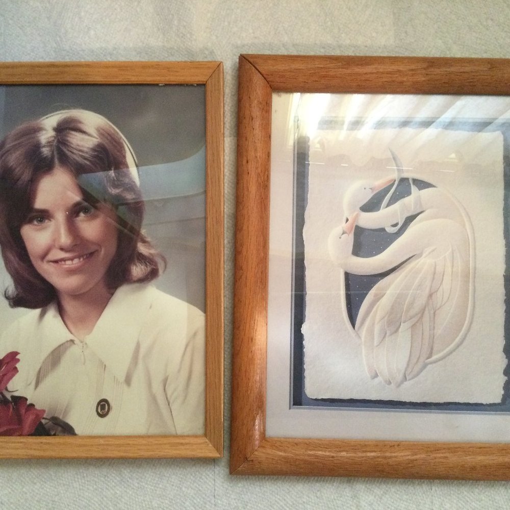 Two wood frames with prints woman portrait and swan